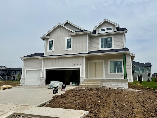 1258 S 92nd St, West Des Moines, IA 50266 - view of front of property featuring a garage, driveway, and board and batten siding