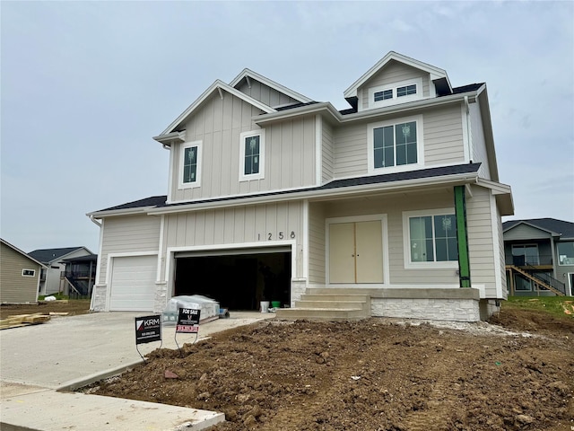 1258 S 92nd St, West Des Moines, IA 50266 - view of front facade with a garage, board and batten siding, and driveway