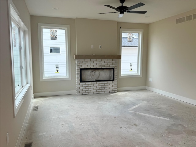 1258 S 92nd St, West Des Moines, IA 50266 - unfurnished living room featuring baseboards, ceiling fan, and a fireplace
