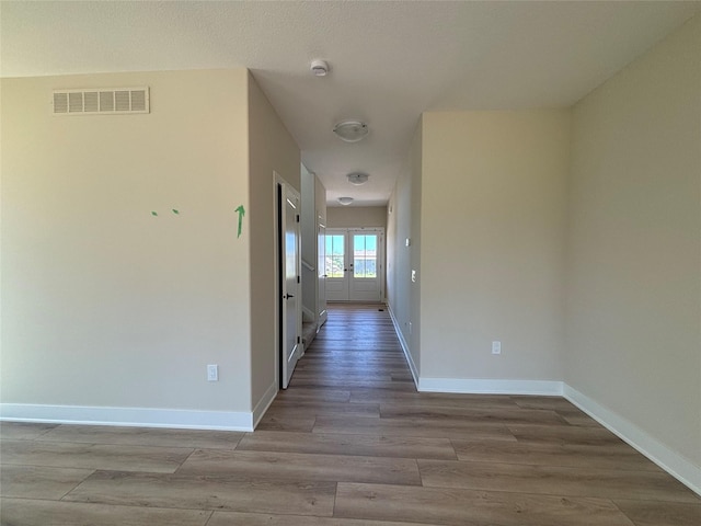 1258 S 92nd St, West Des Moines, IA 50266 - corridor with wood finished floors and french doors