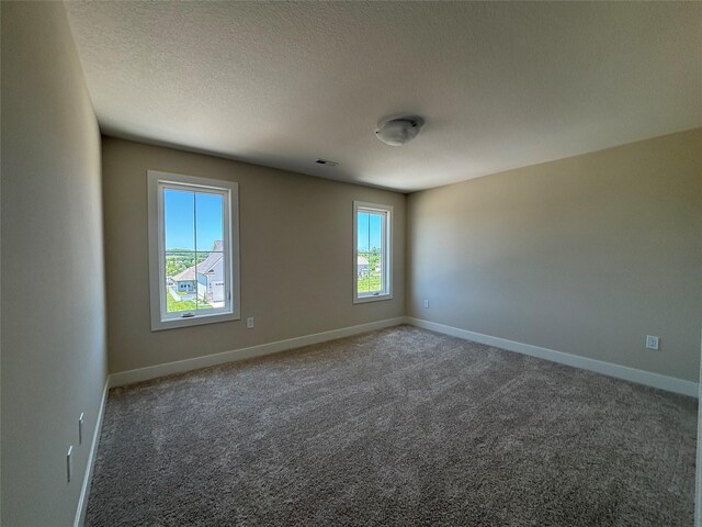 1258 S 92nd St, West Des Moines, IA 50266 - empty room with carpet flooring and a textured ceiling