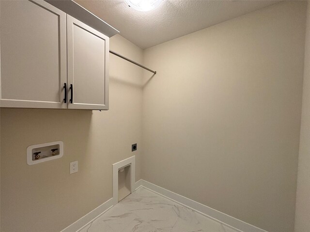 1258 S 92nd St, West Des Moines, IA 50266 - laundry room with cabinet space, electric dryer hookup, hookup for a washing machine, light marble finish floors, and a textured ceiling