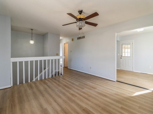 1309 Stewart St, Des Moines, IA 50316 - unfurnished room featuring baseboards, a ceiling fan, visible vents, and light wood-type flooring
