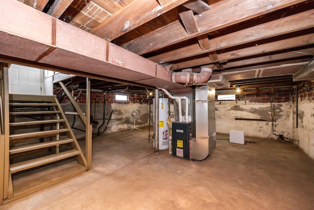 unfinished below grade area featuring heating unit, gas water heater, and stairway