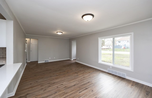 unfurnished living room with visible vents and ornamental molding