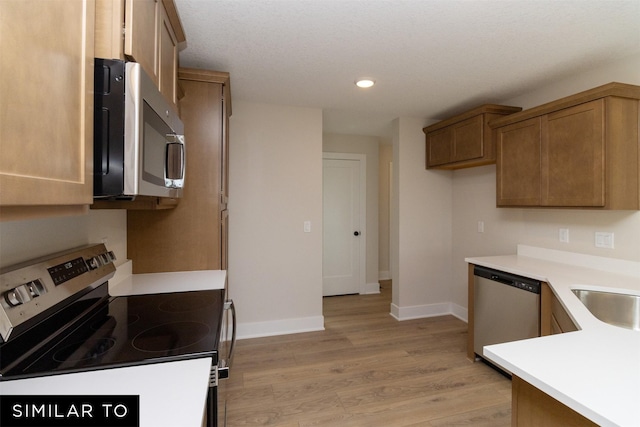4312 NE 8th St, Ankeny, IA 50021 - kitchen with baseboards, appliances with stainless steel finishes, light wood-style flooring, and recessed lighting