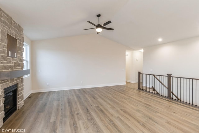 4308 NE 8th St, Ankeny, IA 50021 - unfurnished living room featuring vaulted ceiling, wood finished floors, a ceiling fan, baseboards, and a fireplace