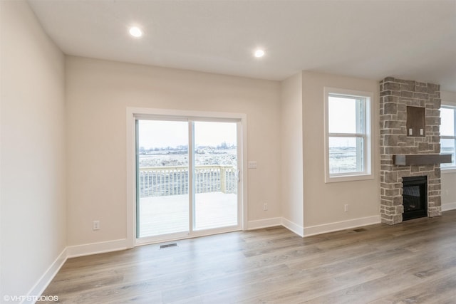 4308 NE 8th St, Ankeny, IA 50021 - unfurnished living room with baseboards, wood finished floors, and a fireplace