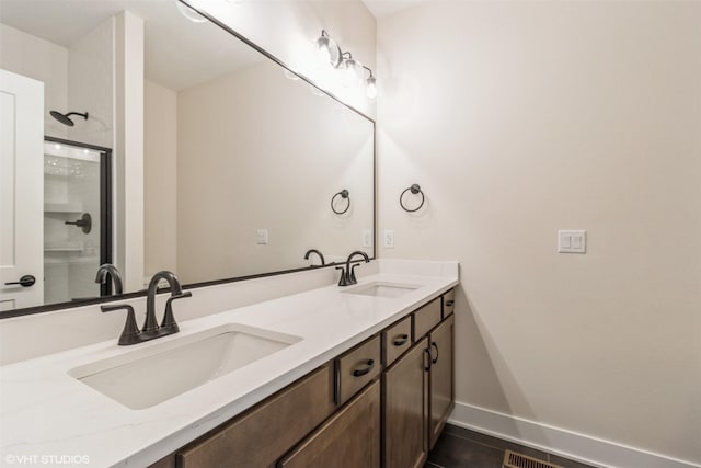 4308 NE 8th St, Ankeny, IA 50021 - bathroom with baseboards, a sink, double vanity, and a stall shower