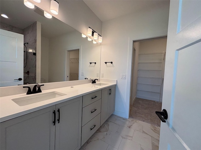 4655 178th St, Urbandale, IA 50263 - full bath with a walk in closet, double vanity, marble finish floors, a shower, and baseboards