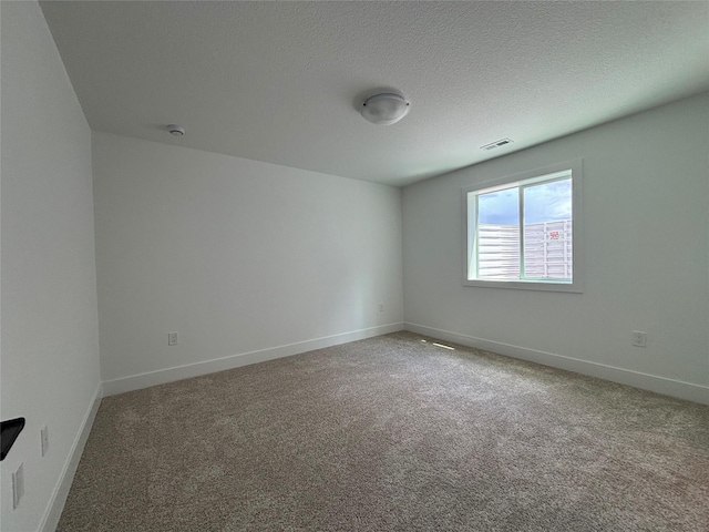 4655 178th St, Urbandale, IA 50263 - empty room with carpet, baseboards, a smoke detector, and a textured ceiling