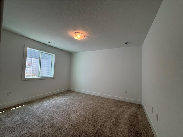 4655 178th St, Urbandale, IA 50263 - carpeted spare room featuring baseboards and a textured ceiling