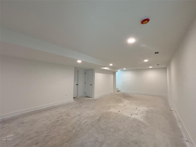 finished below grade area with stairway, baseboards, and recessed lighting