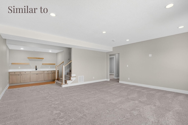 2934 Lake Hill Dr, Des Moines, IA 50320 - unfurnished living room with light colored carpet, wet bar, stairs, and recessed lighting