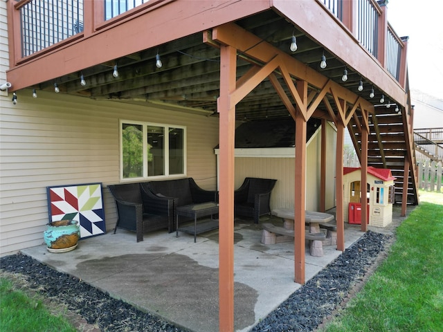 view of patio featuring stairway and an outdoor living space