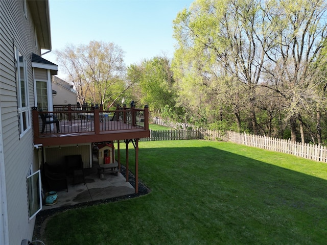 view of yard with a fenced backyard, a deck, and a patio
