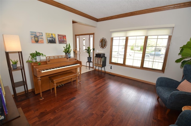sitting room featuring dark wood-type flooring, baseboards, and ornamental molding