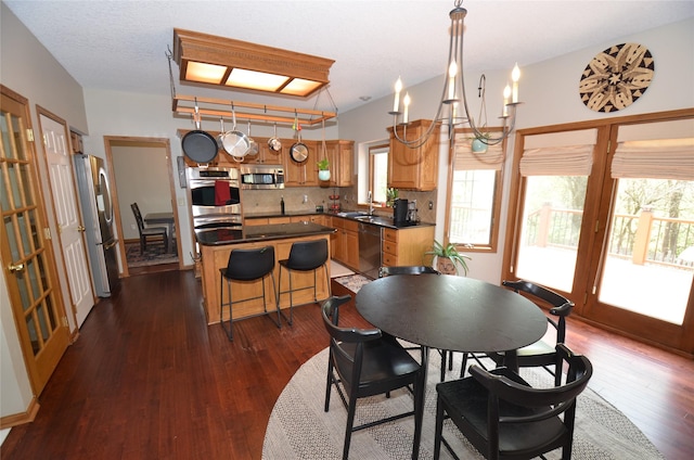 dining space with a notable chandelier and dark wood-type flooring