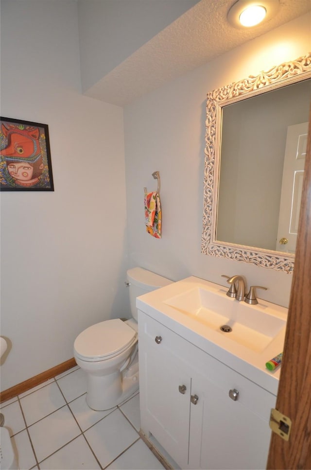 bathroom with vanity, tile patterned flooring, a textured ceiling, and toilet