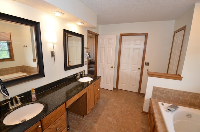 bathroom featuring a bath, a sink, and double vanity