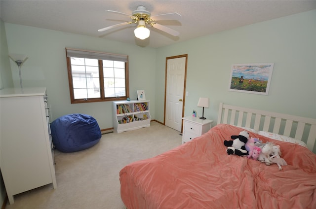 bedroom with baseboards, light colored carpet, and ceiling fan