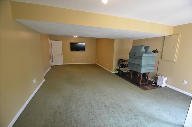 finished below grade area featuring baseboards and carpet flooring