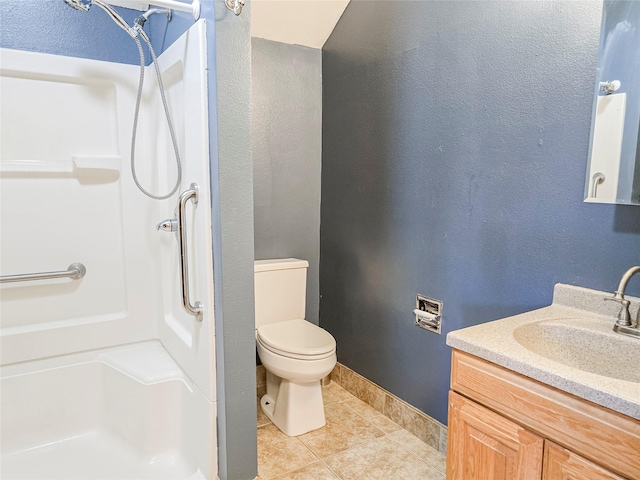 bathroom with toilet, walk in shower, vanity, and tile patterned floors
