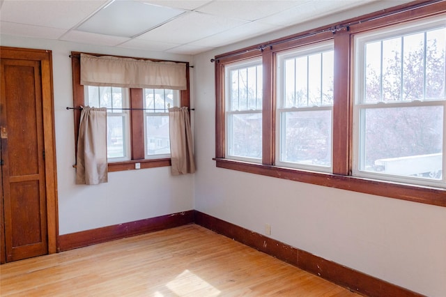empty room featuring baseboards and light wood-type flooring