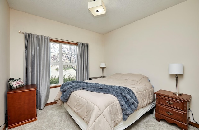 carpeted bedroom with baseboards