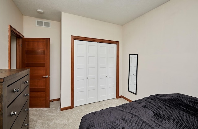 bedroom with light colored carpet, baseboards, visible vents, and a closet