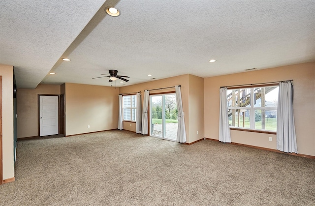 unfurnished living room featuring recessed lighting, carpet, a textured ceiling, and baseboards