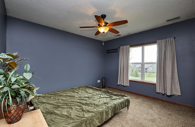 carpeted bedroom featuring baseboards, a ceiling fan, a textured ceiling, and visible vents