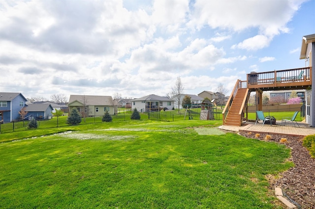 view of yard with a deck, a fenced backyard, a patio, a residential view, and stairs