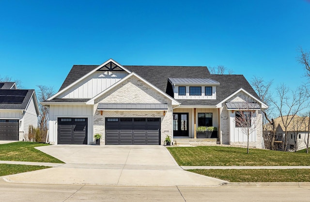 view of front of property featuring a front lawn, concrete driveway, board and batten siding, an attached garage, and brick siding