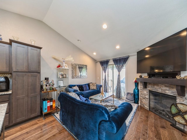 1110 NE 15th Ln, Ankeny, IA 50021 - living area with lofted ceiling, a stone fireplace, light wood finished floors, and recessed lighting