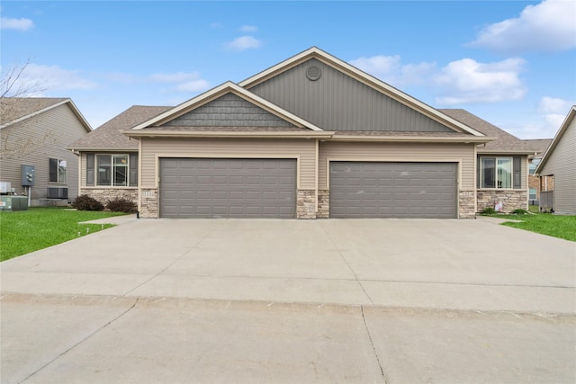 1110 NE 15th Ln, Ankeny, IA 50021 - craftsman-style home with stone siding, concrete driveway, a garage, a shingled roof, and a front yard