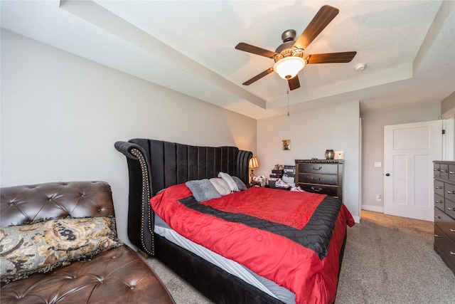 1110 NE 15th Ln, Ankeny, IA 50021 - bedroom featuring a raised ceiling, carpet flooring, baseboards, and ceiling fan