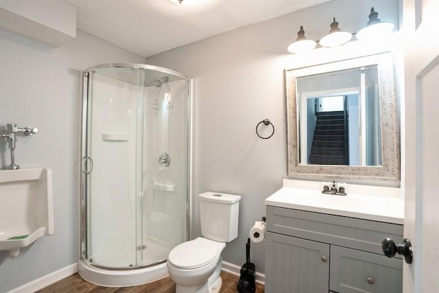 717 37th St SW, Bondurant, IA 50035 - full bathroom with a shower stall, toilet, baseboards, and wood finished floors