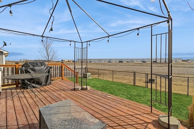 717 37th St SW, Bondurant, IA 50035 - wooden terrace featuring fence, a lawn, and a rural view
