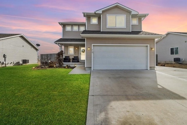 717 37th St SW, Bondurant, IA 50035 - traditional home featuring a front lawn, cooling unit, a porch, concrete driveway, and an attached garage