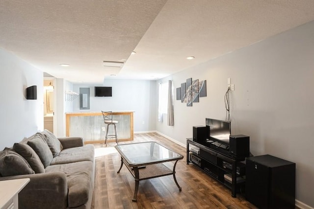 717 37th St SW, Bondurant, IA 50035 - living room featuring baseboards, dark wood-style flooring, and a dry bar