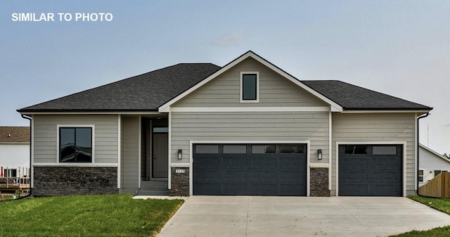 530 Walnut Dr, Huxley, IA 50124 - view of front of property with stone siding, driveway, a front lawn, a garage, and roof with shingles