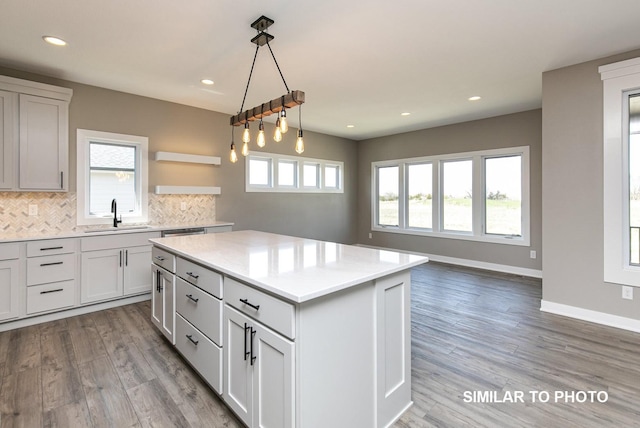 530 Walnut Dr, Huxley, IA 50124 - kitchen with healthy amount of natural light, tasteful backsplash, recessed lighting, wood finished floors, and a kitchen island