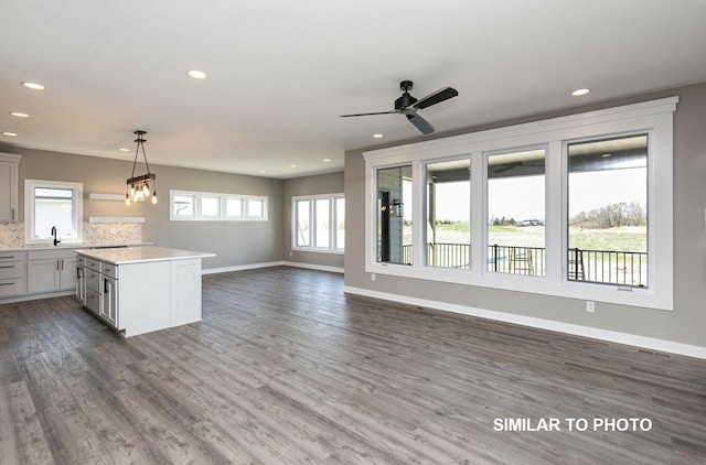 530 Walnut Dr, Huxley, IA 50124 - kitchen featuring light countertops, open floor plan, recessed lighting, dark wood finished floors, and decorative backsplash