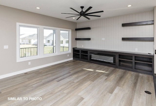 530 Walnut Dr, Huxley, IA 50124 - unfurnished living room with wood finished floors, recessed lighting, and ceiling fan