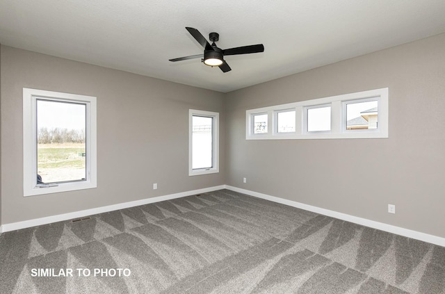 530 Walnut Dr, Huxley, IA 50124 - spare room with dark colored carpet and ceiling fan