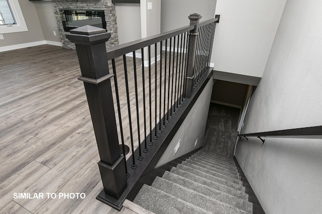 530 Walnut Dr, Huxley, IA 50124 - staircase with wood finished floors and a stone fireplace