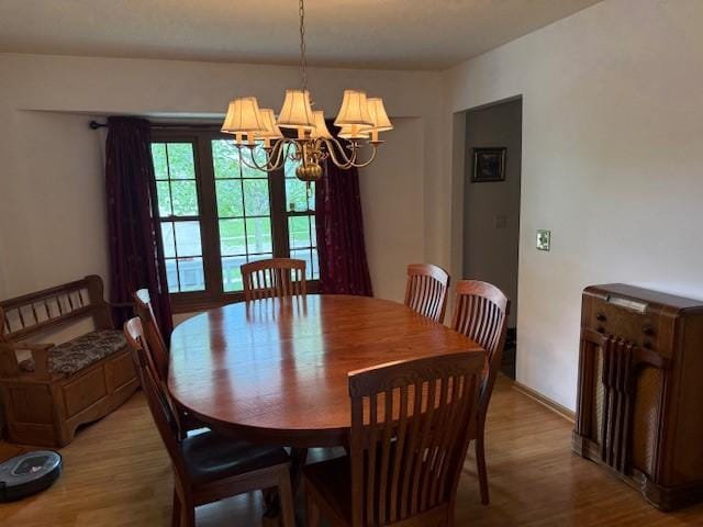 4508 49th St, Des Moines, IA 50310 - dining space with a chandelier and light wood-type flooring