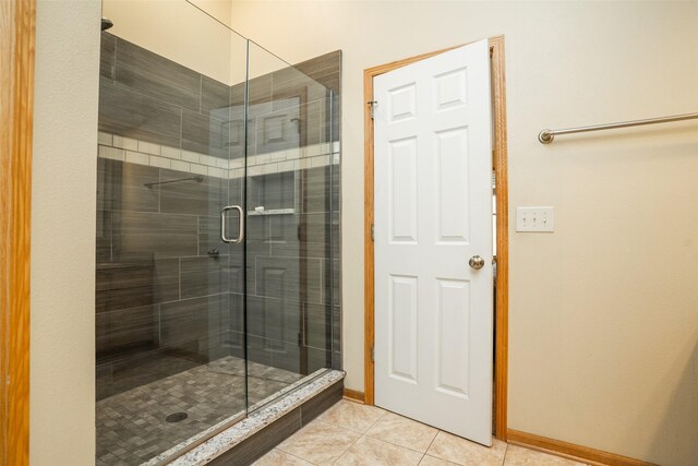 748 76th St, West Des Moines, IA 50266 - bathroom featuring baseboards, tile patterned flooring, and a shower stall