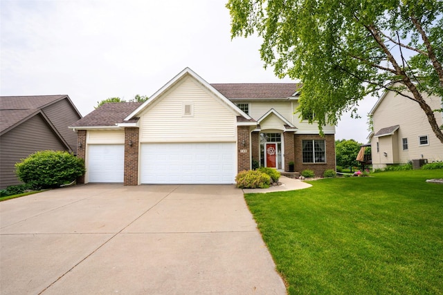 748 76th St, West Des Moines, IA 50266 - traditional home featuring brick siding, driveway, a front yard, and a garage